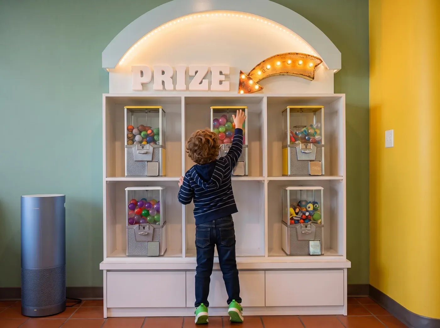 A child choosing from the prize wall