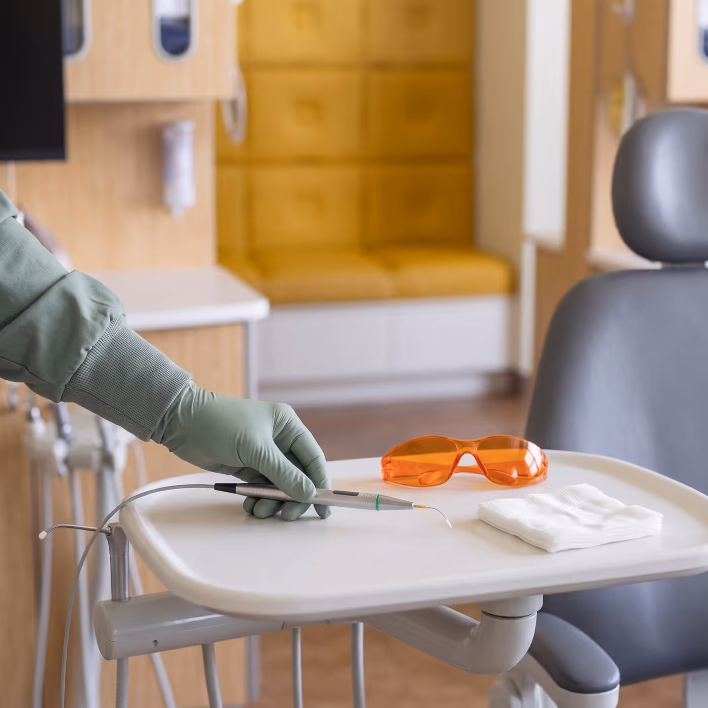 The laser handpiece and protective eyewear laid out chairside for a frenectomy